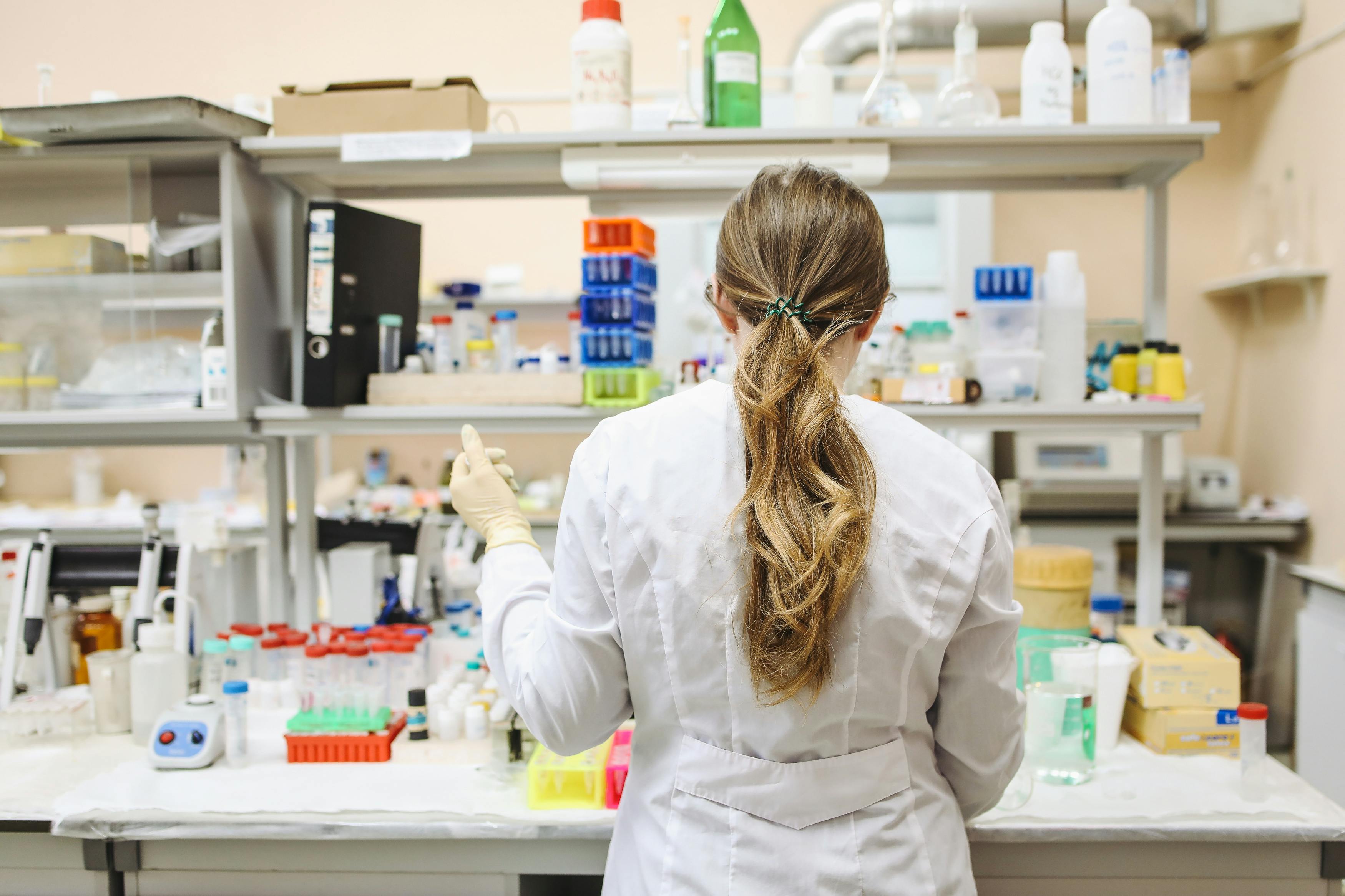 Female scientist looking in microscope.